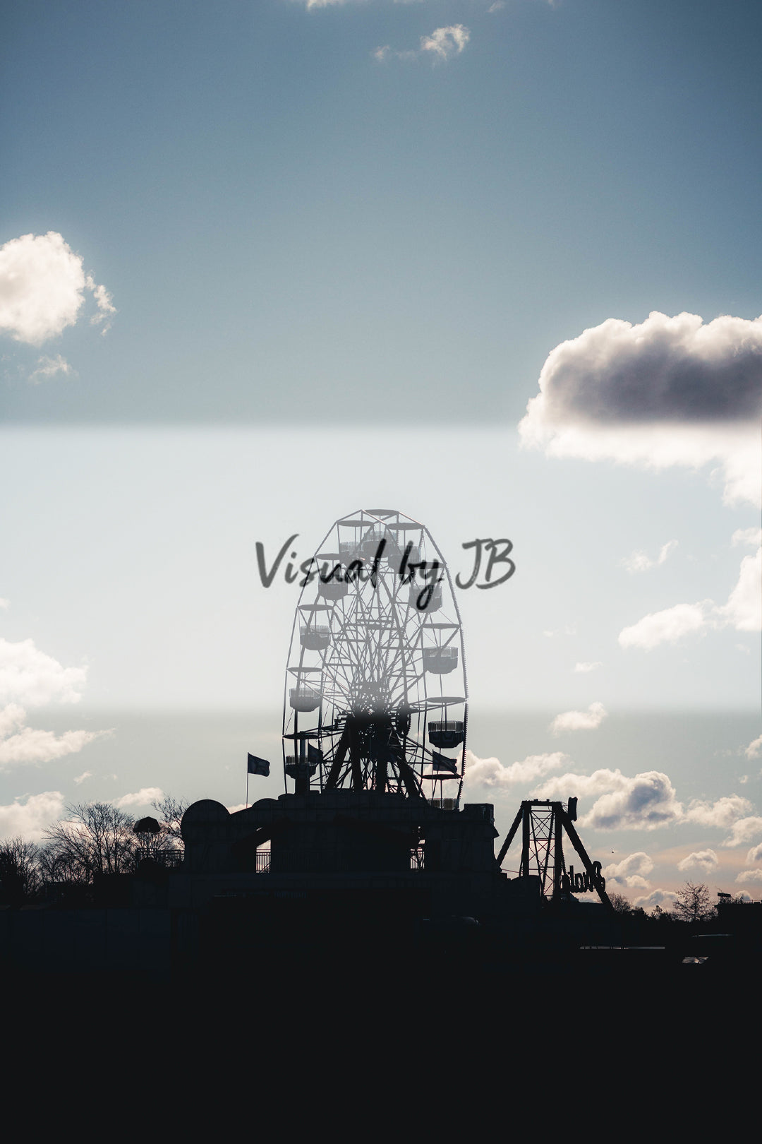 Ferris wheel silhouette against dramatic cloudy sky, fine art photography print